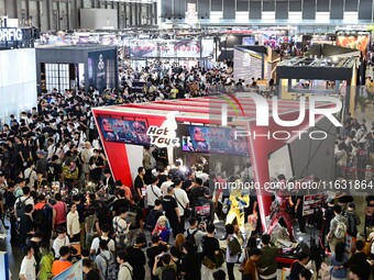 Visitors look at a handmade model on display at the Wonder Festival 2024 in Shanghai, China, on October 2, 2024. (