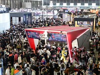 Visitors look at a handmade model on display at the Wonder Festival 2024 in Shanghai, China, on October 2, 2024. (