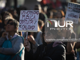 A woman holds a sign that reads ''Free and quality public university'' during a protest against Argentina's President Javier Milei's promise...