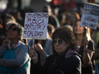 A woman holds a sign that reads ''Free and quality public university'' during a protest against Argentina's President Javier Milei's promise...