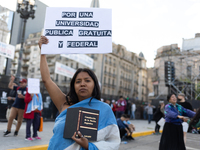 A woman holds a sign that reads ''For a public, free and federal university'' during a protest against Argentina's President Javier Milei's...