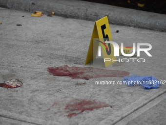 The NYPD Crime Scene Unit canvasses the area outside a senior center where 40-year-old Kavon Reid collapses after he is shot in Bronx, New Y...