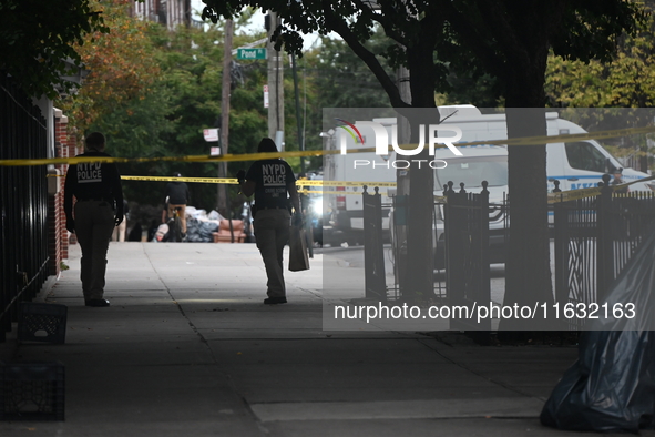 The NYPD Crime Scene Unit canvasses the area outside a senior center where 40-year-old Kavon Reid collapses after he is shot in Bronx, New Y...