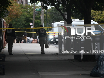 The NYPD Crime Scene Unit canvasses the area outside a senior center where 40-year-old Kavon Reid collapses after he is shot in Bronx, New Y...