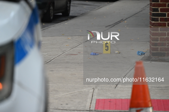 The NYPD Crime Scene Unit canvasses the area outside a senior center where 40-year-old Kavon Reid collapses after he is shot in Bronx, New Y...