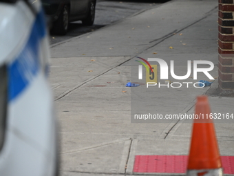 The NYPD Crime Scene Unit canvasses the area outside a senior center where 40-year-old Kavon Reid collapses after he is shot in Bronx, New Y...