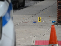 The NYPD Crime Scene Unit canvasses the area outside a senior center where 40-year-old Kavon Reid collapses after he is shot in Bronx, New Y...