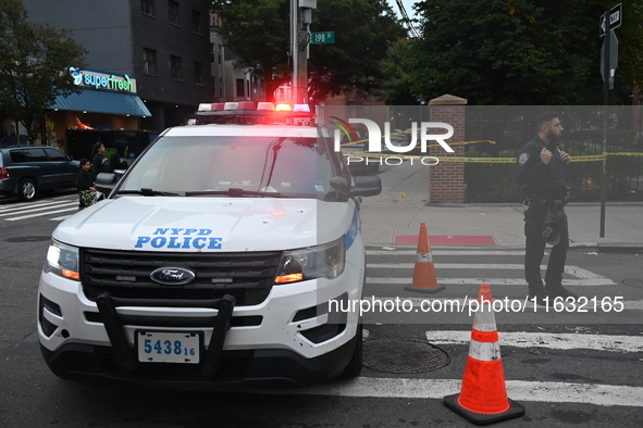 The NYPD Crime Scene Unit canvasses the area outside a senior center where 40-year-old Kavon Reid collapses after he is shot in Bronx, New Y...