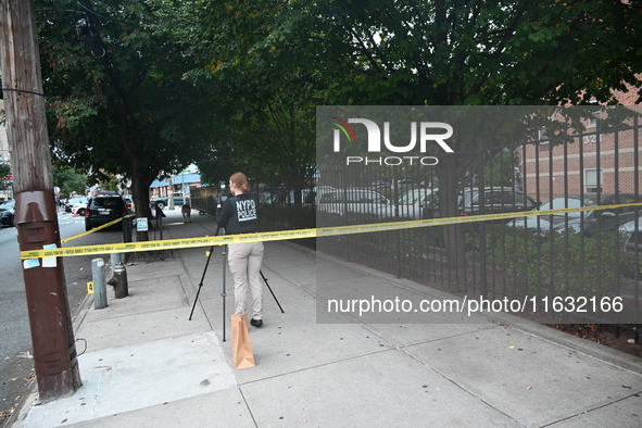 The NYPD Crime Scene Unit canvasses the area outside a senior center where 40-year-old Kavon Reid collapses after he is shot in Bronx, New Y...