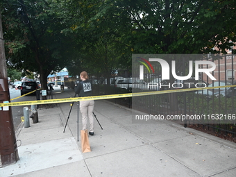 The NYPD Crime Scene Unit canvasses the area outside a senior center where 40-year-old Kavon Reid collapses after he is shot in Bronx, New Y...