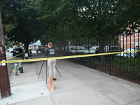 The NYPD Crime Scene Unit canvasses the area outside a senior center where 40-year-old Kavon Reid collapses after he is shot in Bronx, New Y...