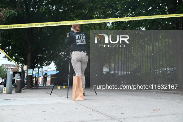 The NYPD Crime Scene Unit canvasses the area outside a senior center where 40-year-old Kavon Reid collapses after he is shot in Bronx, New Y...