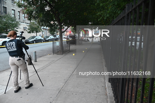 The NYPD Crime Scene Unit canvasses the area outside a senior center where 40-year-old Kavon Reid collapses after he is shot in Bronx, New Y...