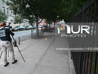 The NYPD Crime Scene Unit canvasses the area outside a senior center where 40-year-old Kavon Reid collapses after he is shot in Bronx, New Y...