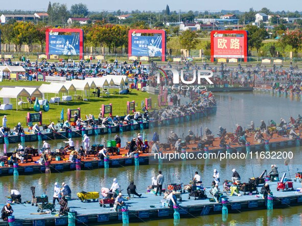 Participants take part in a fishing contest at Sihong International Round Pond in Suqian, China, on October 2, 2024. 