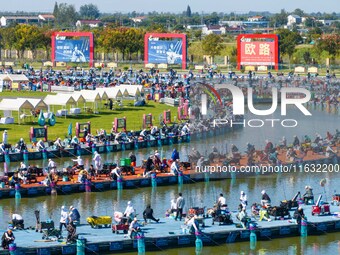 Participants take part in a fishing contest at Sihong International Round Pond in Suqian, China, on October 2, 2024. (