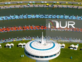 Participants take part in a fishing contest at Sihong International Round Pond in Suqian, China, on October 2, 2024. (