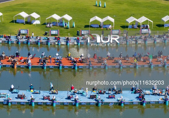 Participants take part in a fishing contest at Sihong International Round Pond in Suqian, China, on October 2, 2024. 