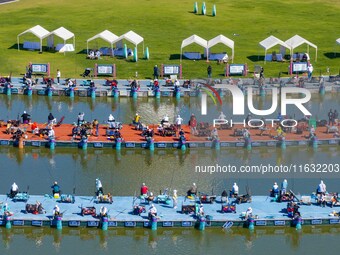 Participants take part in a fishing contest at Sihong International Round Pond in Suqian, China, on October 2, 2024. (