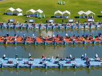 Participants take part in a fishing contest at Sihong International Round Pond in Suqian, China, on October 2, 2024. (