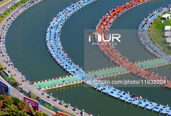 Participants take part in a fishing contest at Sihong International Round Pond in Suqian, China, on October 2, 2024. 