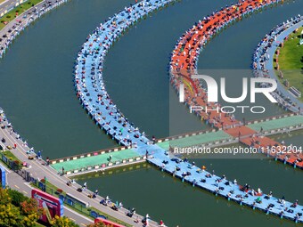 Participants take part in a fishing contest at Sihong International Round Pond in Suqian, China, on October 2, 2024. (