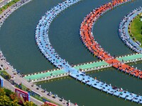 Participants take part in a fishing contest at Sihong International Round Pond in Suqian, China, on October 2, 2024. (