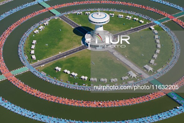 Participants take part in a fishing contest at Sihong International Round Pond in Suqian, China, on October 2, 2024. 