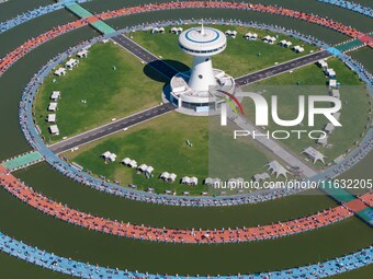 Participants take part in a fishing contest at Sihong International Round Pond in Suqian, China, on October 2, 2024. (