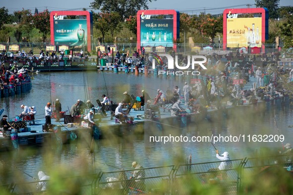 Participants take part in a fishing contest at Sihong International Round Pond in Suqian, China, on October 2, 2024. 