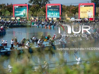 Participants take part in a fishing contest at Sihong International Round Pond in Suqian, China, on October 2, 2024. (