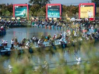 Participants take part in a fishing contest at Sihong International Round Pond in Suqian, China, on October 2, 2024. (