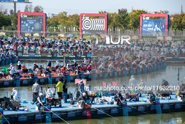 Participants take part in a fishing contest at Sihong International Round Pond in Suqian, China, on October 2, 2024. 