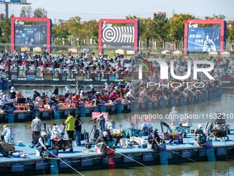 Participants take part in a fishing contest at Sihong International Round Pond in Suqian, China, on October 2, 2024. (