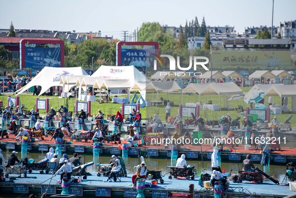 Participants take part in a fishing contest at Sihong International Round Pond in Suqian, China, on October 2, 2024. 