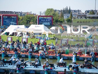 Participants take part in a fishing contest at Sihong International Round Pond in Suqian, China, on October 2, 2024. (