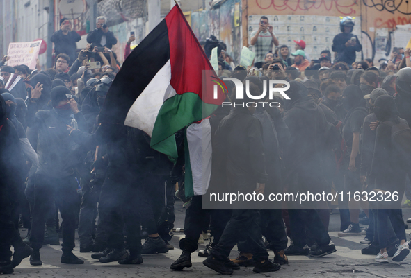 Members of the Anarchist Black Bloc march in Mexico City, Mexico, on October 2, 2024, on the 56th anniversary of the Tlatelolco Massacre tha...