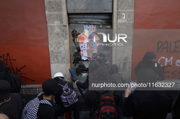 Members of the Bloque Negro Anarquista (Anarchist Black Bloc) take action on establishments in Mexico City, Mexico, on October 2, 2024, duri...