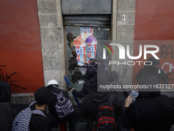 Members of the Bloque Negro Anarquista (Anarchist Black Bloc) take action on establishments in Mexico City, Mexico, on October 2, 2024, duri...