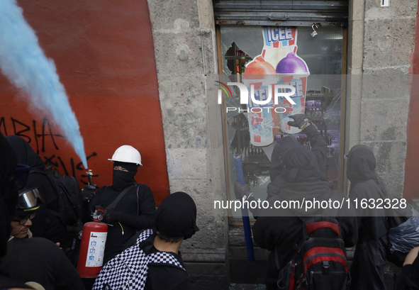 Members of the Bloque Negro Anarquista (Anarchist Black Bloc) take action on establishments in Mexico City, Mexico, on October 2, 2024, duri...