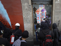 Members of the Bloque Negro Anarquista (Anarchist Black Bloc) take action on establishments in Mexico City, Mexico, on October 2, 2024, duri...