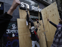 Members of the Bloque Negro Anarquista (Anarchist Black Bloc) take action on establishments in Mexico City, Mexico, on October 2, 2024, duri...