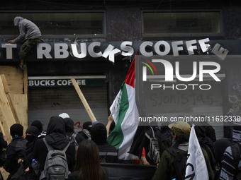 Members of the Bloque Negro Anarquista (Anarchist Black Bloc) take action on establishments in Mexico City, Mexico, on October 2, 2024, duri...