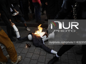 Members of the Bloque Negro Anarquista (Anarchist Black Bloc) take action on establishments in Mexico City, Mexico, on October 2, 2024, duri...