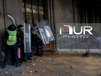 Members of the Anarchist Black Bloc clash with police during the march to mark the 56th anniversary of the Tlatelolco Massacre, which starts...