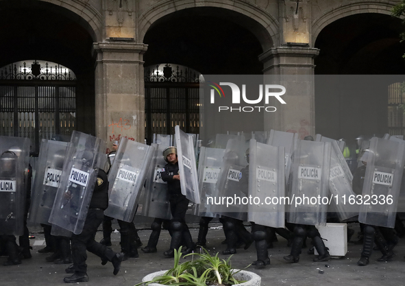 Members of the Anarchist Black Bloc clash with police during the march to mark the 56th anniversary of the Tlatelolco Massacre, which starts...