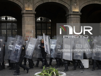 Members of the Anarchist Black Bloc clash with police during the march to mark the 56th anniversary of the Tlatelolco Massacre, which starts...