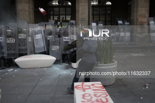 Members of the Anarchist Black Bloc clash with police during the march to mark the 56th anniversary of the Tlatelolco Massacre, which starts...