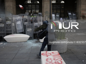 Members of the Anarchist Black Bloc clash with police during the march to mark the 56th anniversary of the Tlatelolco Massacre, which starts...