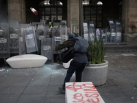 Members of the Anarchist Black Bloc clash with police during the march to mark the 56th anniversary of the Tlatelolco Massacre, which starts...